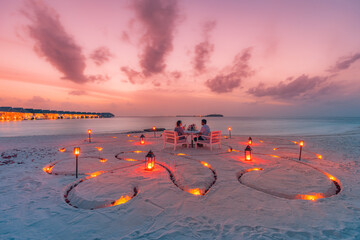 Table setting wedding ceremony on sunset beach. Romantic destination dining, candles romance couple...