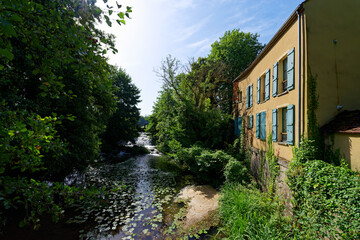 Fototapeta na wymiar Lock on Orvanne river in Moret-Loing-et-Orvanne village. French Gatinais Regional Nature Park
