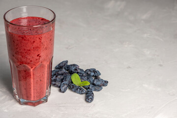 Honeysuckle smoothie on gray background. Healthy food.