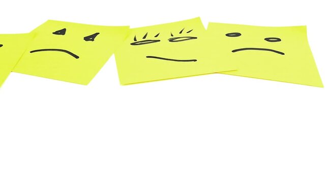 Sad smileys drawn on post-it notes, last smiley face.