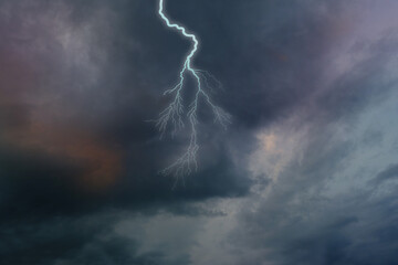 dramatic stormy sky with dark clouds, lightning flashes over the night sky. Concept on the theme of...