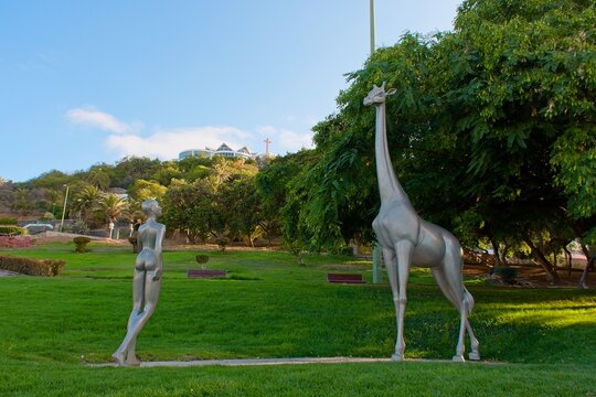 Aluminium sculpture of a nude woman and a giraffe ( Planeta Ella ),symbol of grace and elegance in Doramas Park, Las Palmas de Gran Canaria, Spain