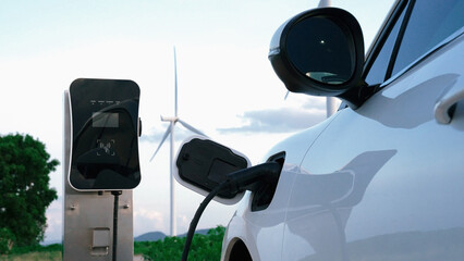 Progressive future energy infrastructure concept of electric vehicle being charged at charging...
