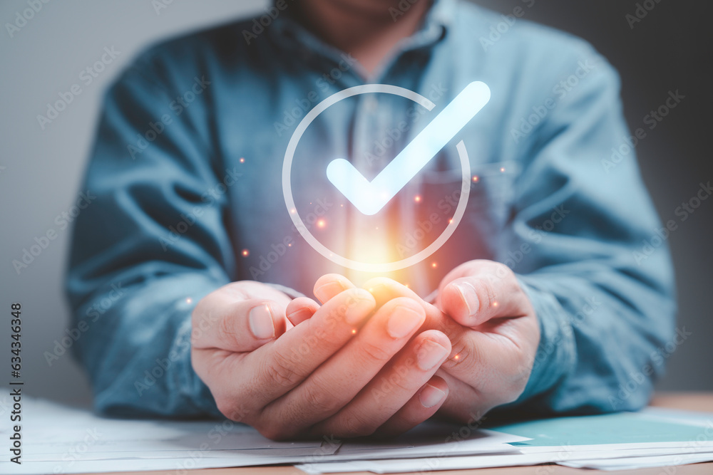 Aufkleber Businessman holding virtual tick correct sign mark in checkbox for quality document control checklist ,document approve and business approve project concept.