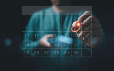 Fototapeta na wymiar Businessman using pen to writing circle mark on virtual calendar agenda of booking and appointment meeting concept.