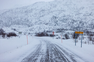 Snowy Road from Kvaloya to Tromso in Norway - 634346904