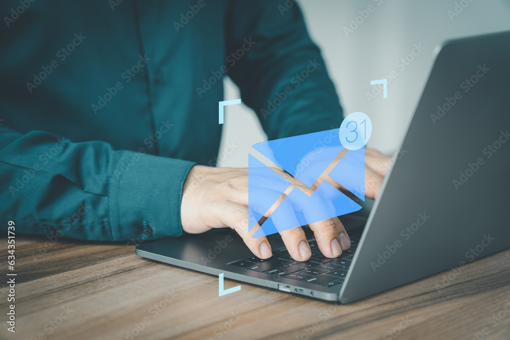 Poster Man hand using computer laptop typing on keyboard and surfing the internet on office table with email icon. Concept of Email marketing, send e-mail or news letter, online working internet network.