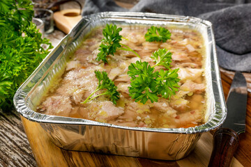 Jelly with shredded chicken meat in a mold.