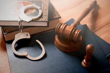 Handcuffs and wooden gavel. Crime concept.