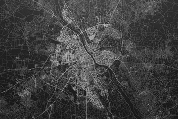 Street map of Warsaw (Poland) on black paper with light coming from top