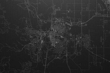 Street map of Rapid City (South Dakota, USA) on black paper with light coming from top