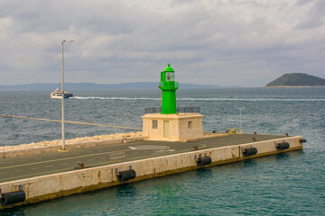 Fototapeta premium A small lighthouse in the port of the historic coastal city of Split in Dalmatia, Croatia
