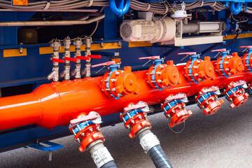 Hoses are connected to fuel equipment. Petroleum transfer system. Hoses for pumping gasoline....