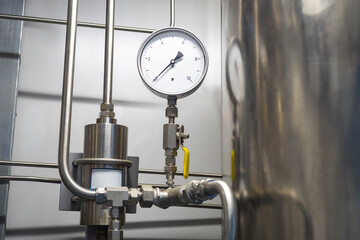 Gas pressure gauge. Propane supply equipment. Mechanical pressure sensor. Thin steel tubes with...