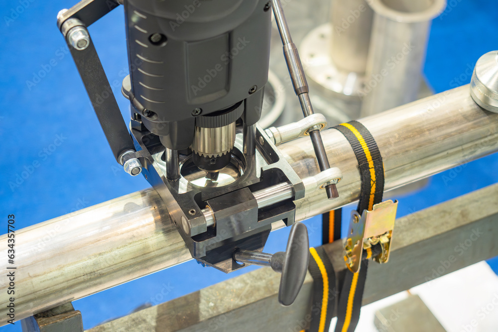 Poster drilling machine on pipe. equipment for pipeline installation. industrial drilling machine. process 