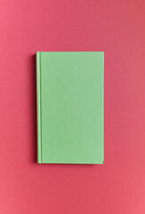 light green book on a red background