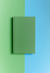 light green book on a green-blue background