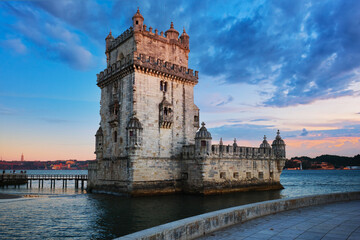 Belem Tower or Tower of St Vincent - famous tourist landmark of Lisboa and tourism attraction - on the bank of the Tagus River (Tejo) in evening dusk after sunset with dramatic sky. Lisbon, Portugal - 634358757