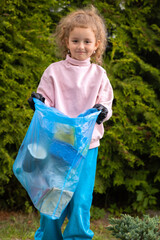 Girl collection plastic garbage in nature. kid picking up trash in park. Earth Day April 22. Save planet. Young volunteer child cleaning forest environment from rubbish pollution World Environment Day