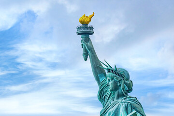 New York, New York, United States. August 07, 2023. Dramatic and detailed image of the Statue of Liberty with strong shades of green, sky with many clouds and very high resolution. - obrazy, fototapety, plakaty