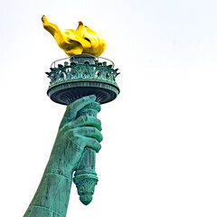 New York, New York, United States. August 07, 2023. Dramatic and detailed image of the Statue of Liberty with strong shades of green, sky with many clouds and very high resolution.