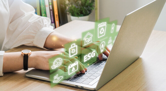 ESG environment social governance investment business concept. Women use a computer to analyze ESG, surrounded by ESG icons .close to the computer screen in business investment strategy concept.