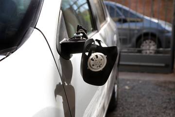 
Car with broken and hanging rearview mirror. Car insured in a car insurance company with a traffic...