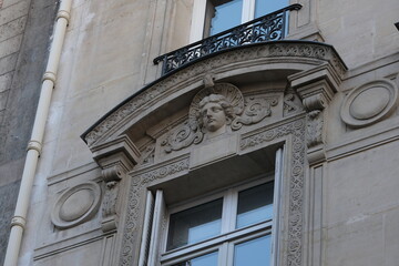 Fancy ornament details and decorations shot on Paris building facades. Doors and windows surround, decorated balconies.