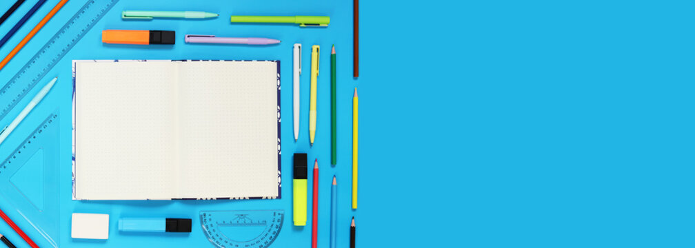 Mockup open notepad with stationery on a blue background. Top view, flat lay. Diary for entries, copy space. Open notebook with space for text with colorful school supplies - Powered by Adobe