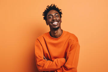 Obraz premium Smiling African American Man with Vibrant Orange Studio Background