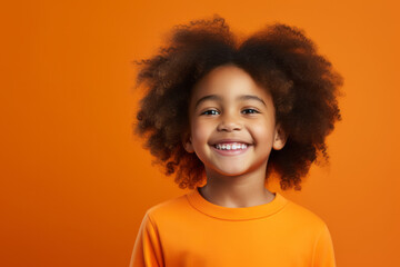 Joyful African American Girl with Vibrant Orange Studio Background