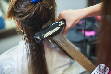 Hair straightening with keratin and a hair iron