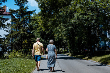 Man and woman walking on way. Unrecognized couple. Summer copy space.