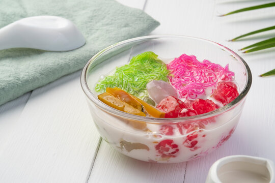 Chilled sweet vermicelli in coconut milk (salim).Thai Dessert mixed sweet noodles,boiled pumpkin,Sweet waterchestnuts and nipa palm fruit in glass bowl