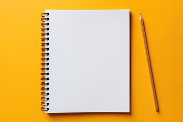 school notebook on a yellow background, spiral notepad on a table