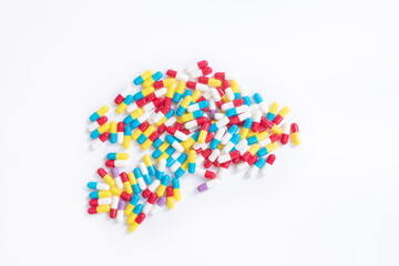 Multicolored tablets lie on a white background. 