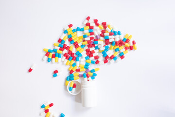 Assorted pharmaceutical medicine pills and capsules and bottle on white background. Copy space for text. 