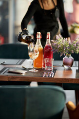 The waiter pours white wine into a glass. Soft focus. luxury living concept. Restaurant. 