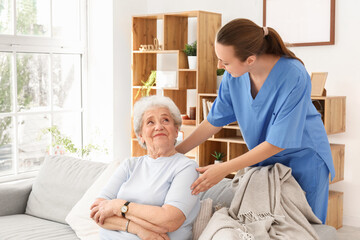 Senior woman with female caregiver at home