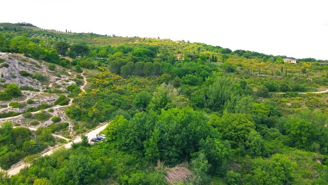 Bagno Vignoni natural pools along the city hill in Tuscany, view in spring season from drone