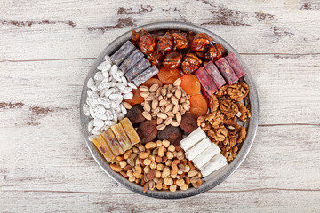 Mixed Nuts. Various nuts, pistachios, almonds, Turkish delight and assorted cookies on a copper tray, view from above.