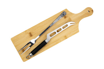 Knife for cutting cheese and forg on cutting board, top view.