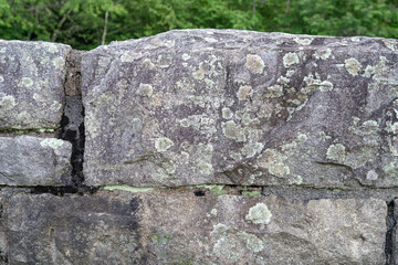 large slabs of stone permanently set in mortar forming a large retaining wall earth barrier...