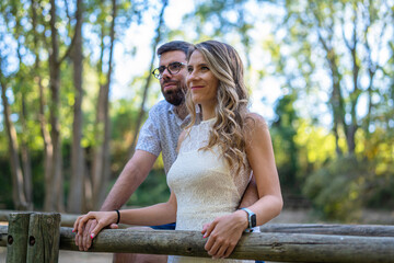 Couple in love enjoying a walk in the woods at sunset