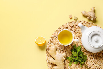 Cup of ginger tea with lemon and mint on yellow background