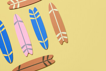 Different mini surfboards on yellow background