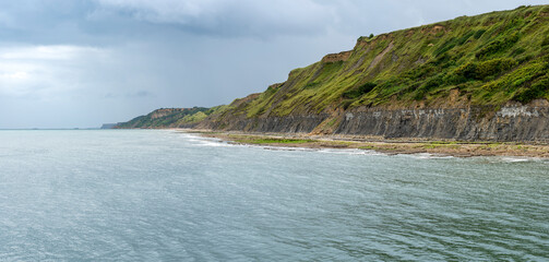 Port-en-Bessin-Huppain, France - 07 24 2023: Panoramic view of the cliffs near Vauban Tower.