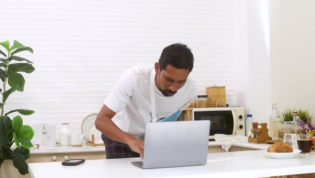 Stress businessman with mustache stays at home cannot work after broken arm accident spilled water on laptop, unhappy middle-aged man frustrated freelancer male angry throws damage laptop on table
