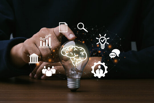 Skills,Knowledge and Ability.Man hand touching light bulb with icon of skills.Thinking, Creativity, Management, Digital skill.Education concept.