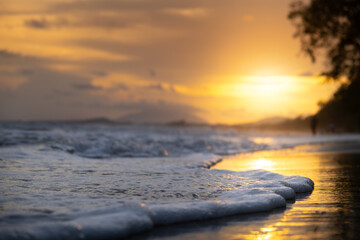 Sea waves blow on the beach on Phi Phi Island in the evening when the sunset